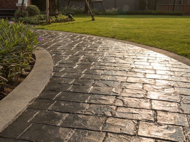 Stamped concrete pathway with a slight sheen in Frisco, Texas.