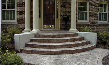 Stamped concrete stairs and landing of a home with white pillars in Frisco, Texas.
